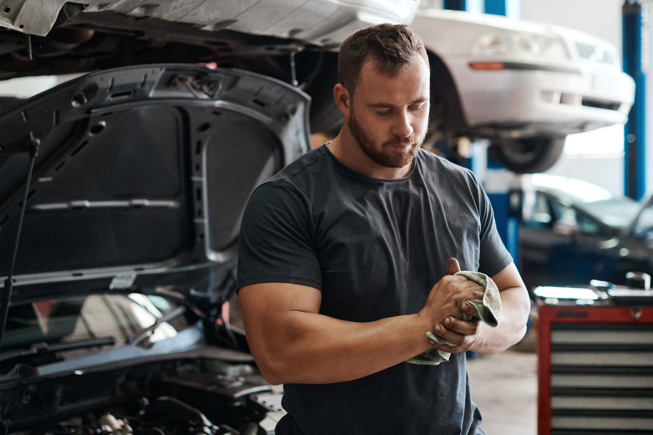 Mechanic wiping hands after vehicle inspection