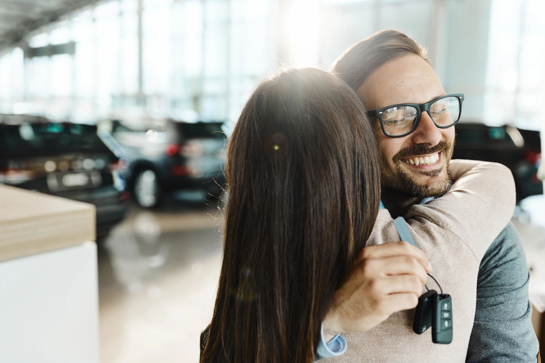 Happy couple in a dealership showroom