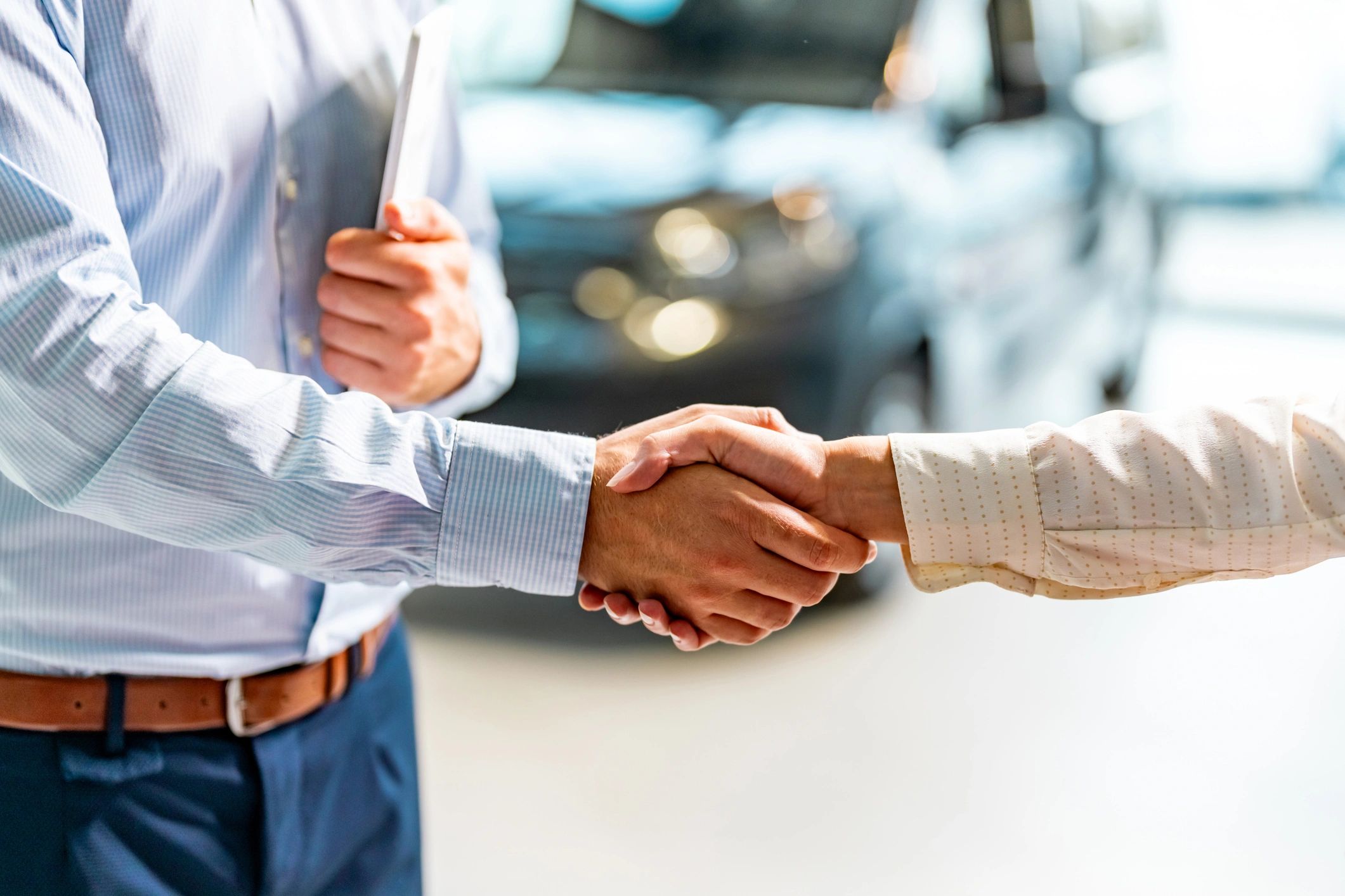 Customer shaking hands with a car dealer