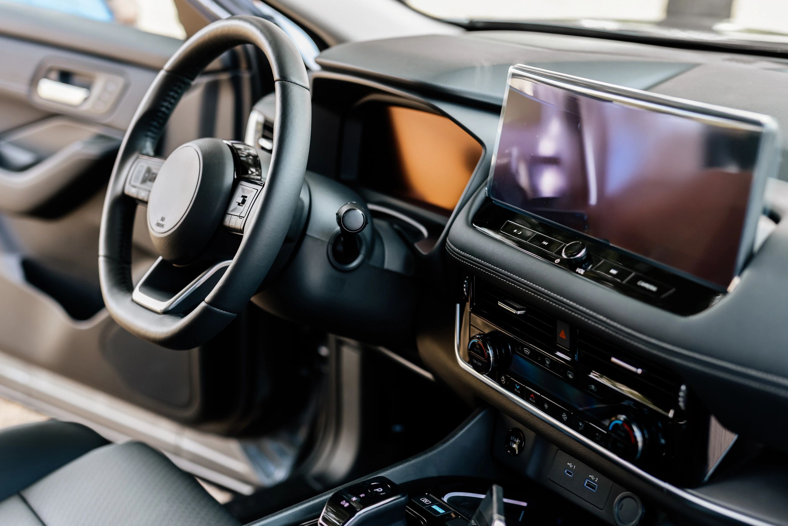 Close-up of a modern car steering wheel and interior