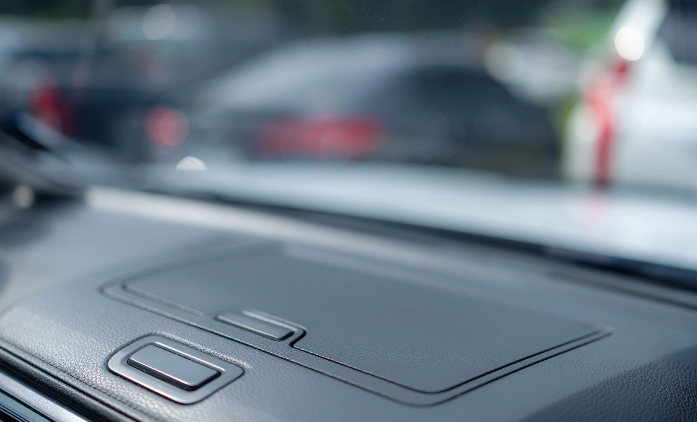 View from inside a car showing dashboard and windshield